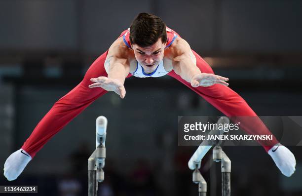 Russia's Artur Dalaloyan performs on the parallel bars during the Men's All-Around final during the Artistic Gymnastics Championships in Szczecin,...