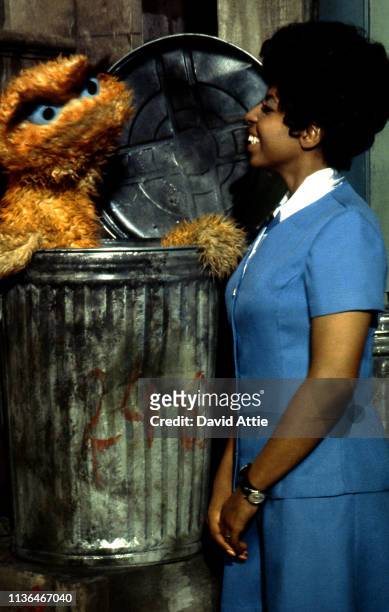 Muppet Oscar the Grouch and actress Loretta Long as the character Susan Robinson during the filming of an episode of Sesame Street at Reeves TeleTape...