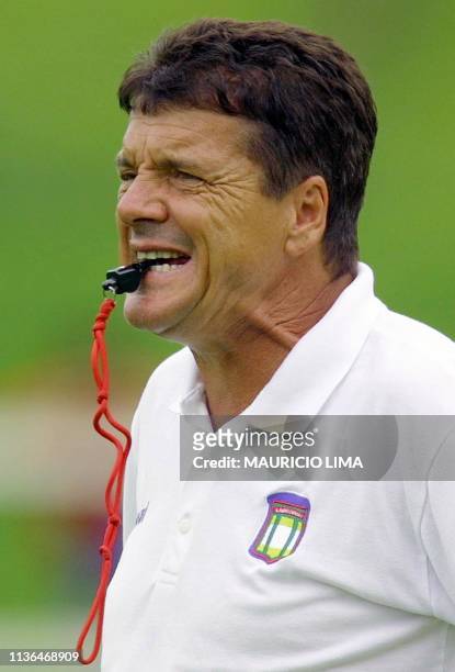 Jair Picerni, a coach of Sao Caetano, watches players during the practice session in Atibaia, 70 km away from Sao Paulo, Brazil, 26 December 2000....