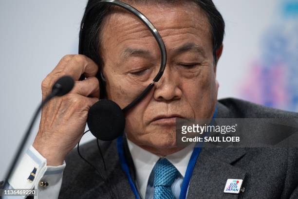 Japanese Finance Minister Taro Aso speaks during the G20 press conference during the IMF - World Bank Spring Meetings at International Monetary Fund...
