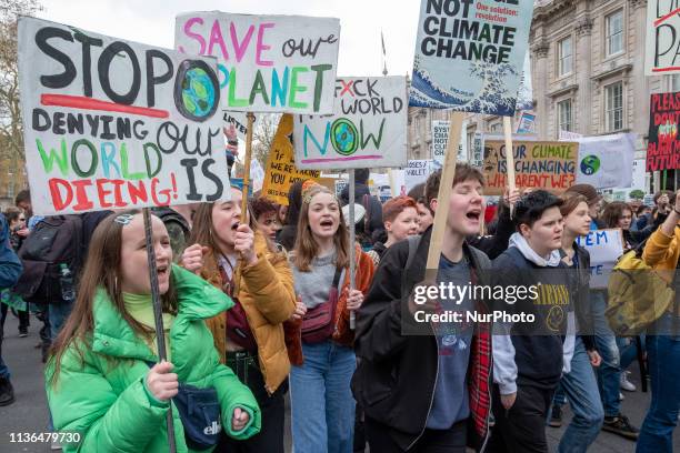 Protesters hold signs at the YouthStrike4Climate student march on April 12, 2019 in London, United Kingdom. Students are protesting across the UK due...