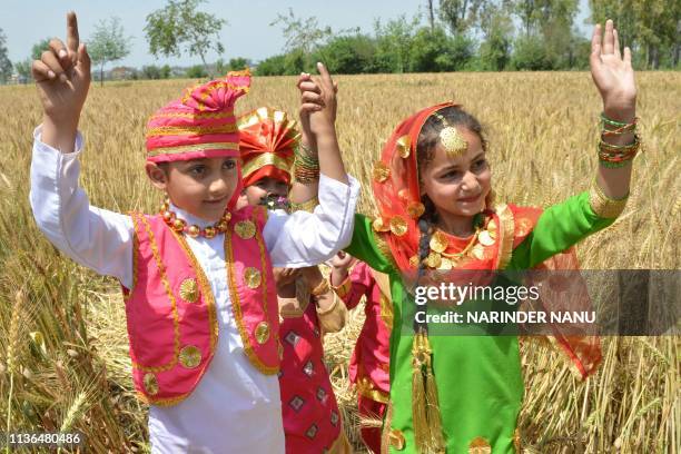 Indian Sikh children perform the traditional Punjab Folk dance "Bhangra" in a wheat field on the outskirts of Amritsar on April 12 on the eve of the...