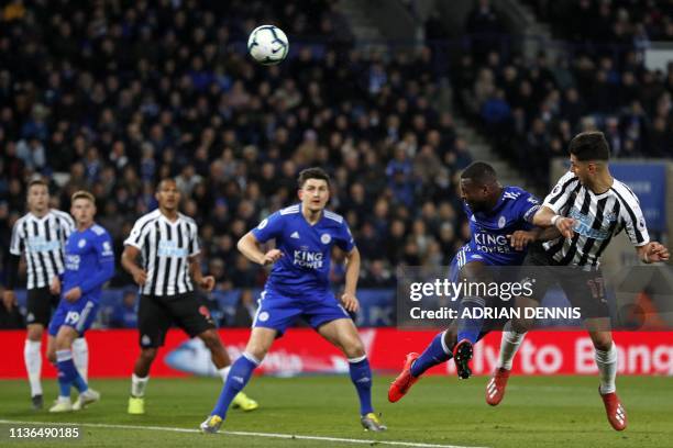 Newcastle United's Spanish striker Ayoze Perez heads home the opening goal under pressure from Leicester City's English-born Jamaican defender Wes...