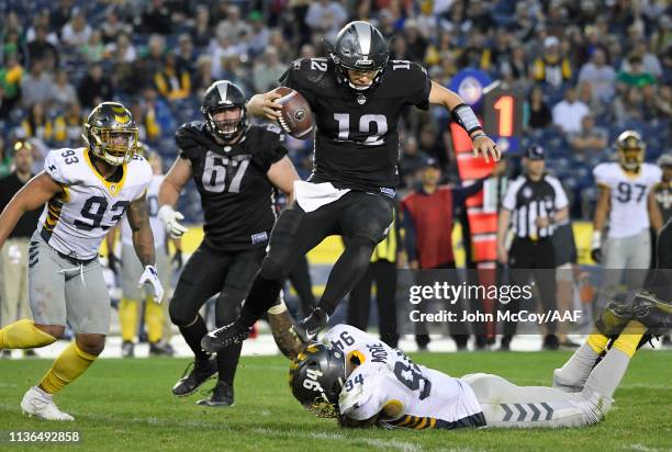 Luis Perez of the Birmingham Iron hurdles Damontre Moore of the San Diego Fleet during the second half in an Alliance of American Football game at...