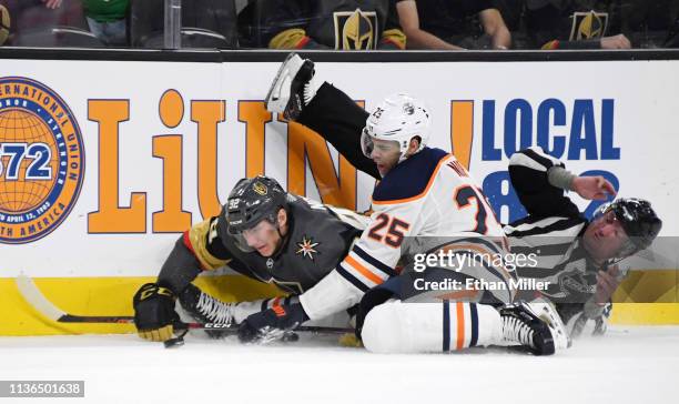 Tomas Nosek of the Vegas Golden Knights and Darnell Nurse of the Edmonton Oilers crash into linesman Derek Nansen as they go after the puck in the...