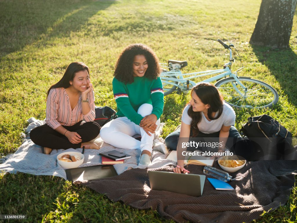 College girls studying together outdoors