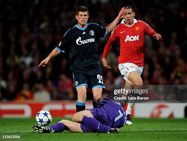 Edwin van der Sar of Manchester United makes a save at the feet of Klaas-Jan Huntelaar of Schalke during the UEFA Champions League Semi Final second...