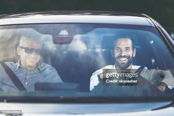 two happy businessmen going on business travel by car. - businessman driving stock pictures, royalty-free photos & images