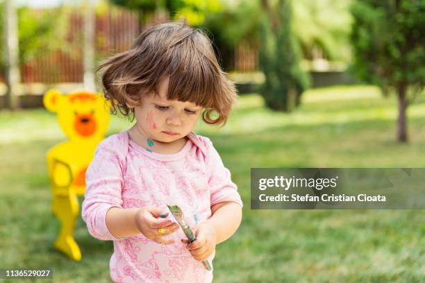 girl playing with painting brush - baby paint hand imagens e fotografias de stock