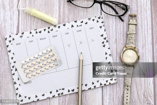 contraceptive pills background and fertil calendar - ovulation stock pictures, royalty-free photos & images