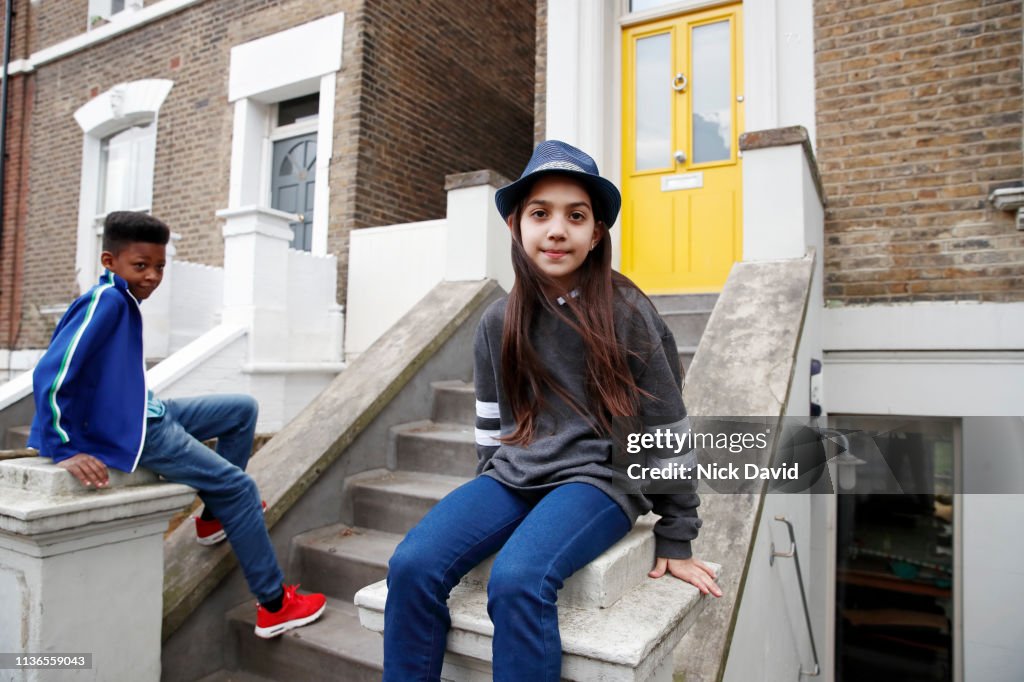 Boy and girl waiting outside front door
