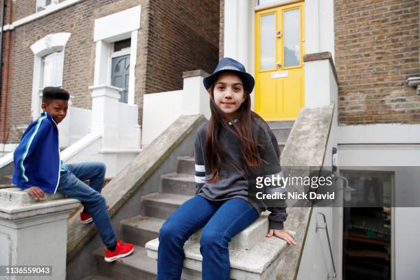 Boy and girl waiting outside front door