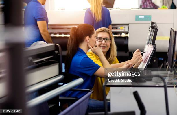 coworkers in printing factory - computer printing stock pictures, royalty-free photos & images