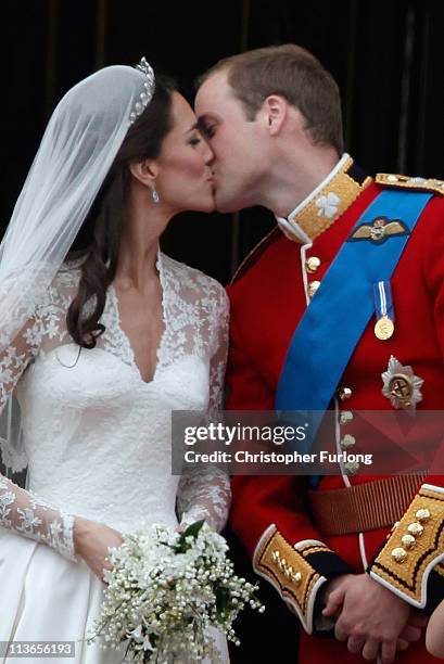 Catherine, Duchess of Cambridge and Prince William, Duke of Cambridge kiss on the balcony at Buckingham Palace on April 29, 2011 in London, England....