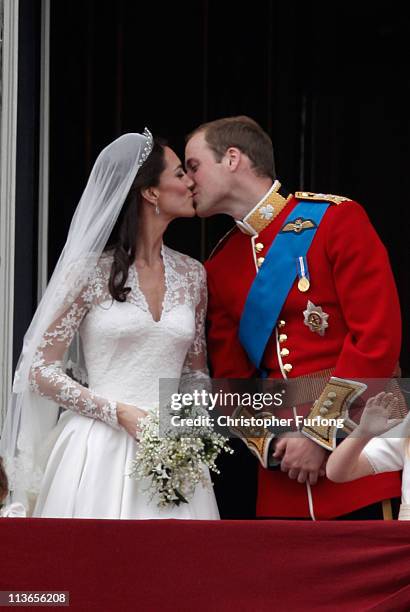 Catherine, Duchess of Cambridge and Prince William, Duke of Cambridge kiss on the balcony at Buckingham Palace on April 29, 2011 in London, England....