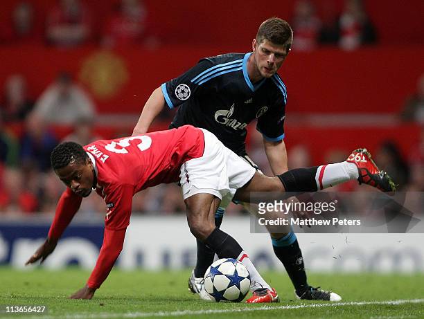 Patrice Evra of Manchester United clashes with Klaas-Jan Huntelaar of Schalke 04 during the UEFA Champions League Semi-Final second leg match between...