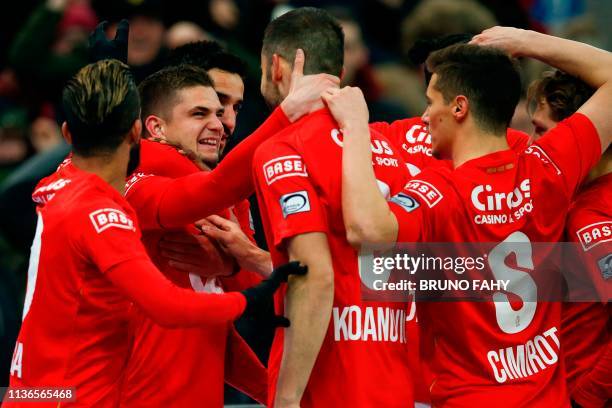 Standard's Romanian midfielder Razvan Marin celebrates with his teammates after scoring during their Play-off 1 on day 4 of the "Jupiler Pro League"...