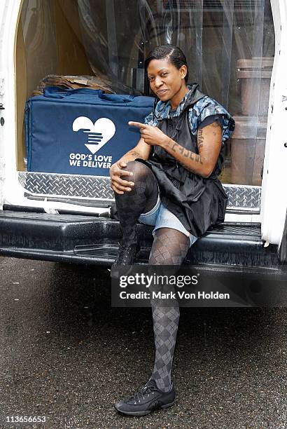 Celebrity AIDS Activist Suzanne Africa Engo wearing Kenneth Cole Aids Awearness rain poncho encourages others to volunteer for Gods Love We Deliver...