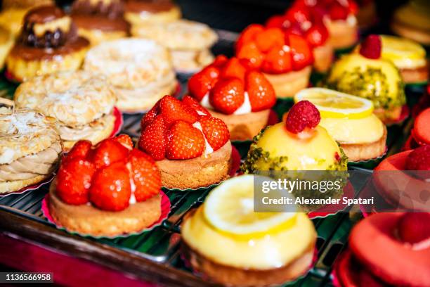 variety of sweet desserts at patisserie display - bakery stockfoto's en -beelden