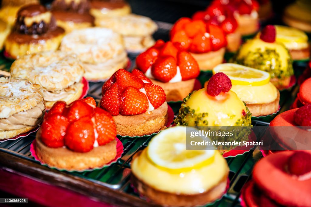 Variety of sweet desserts at patisserie display