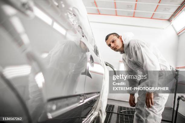 car painting technician checking out paint consistency on a freshly painted door segment - lacquered stock pictures, royalty-free photos & images