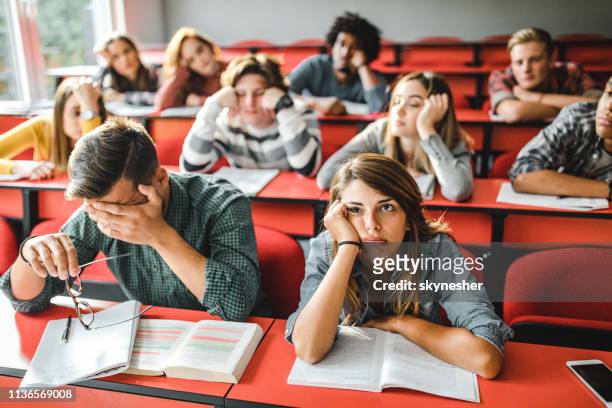 large group of bored students at lecture hall. - bores stock pictures, royalty-free photos & images