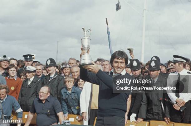 Spanish golfer Seve Ballesteros holds up the Golf Champion claret jug trophy after finishing in first place in the final round to win the 1979 Open...