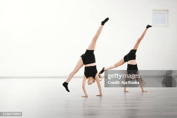 harmonized cartwheel. - acrobatics gymnastics stock pictures, royalty-free photos & images