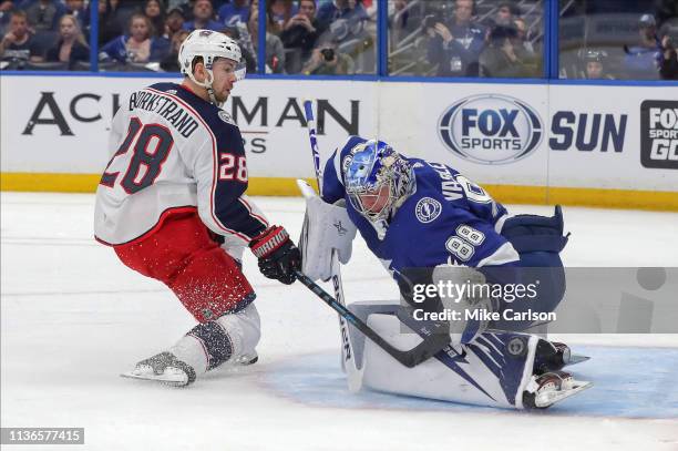 Andrei Vasilevskiy of the Tampa Bay Lightning makes a save against Oliver Bjorkstrand of the Columbus Blue Jackets during the first period in Game...