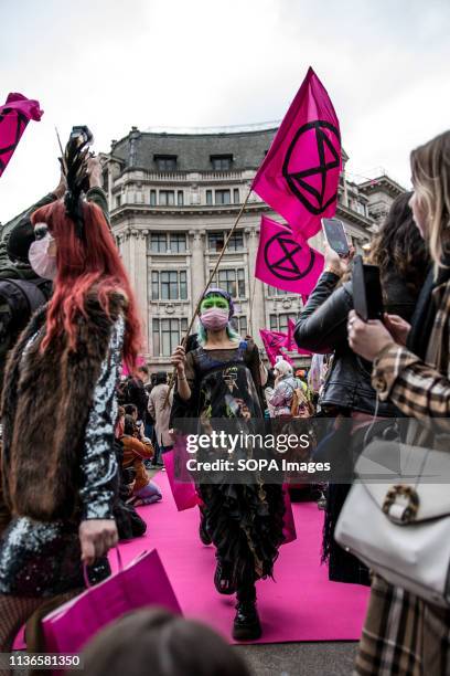 Woman activist seen showcasing an outfit during the Extinction Rebellion fashion show in London. The Extinction Rebellion Fashion Action group...