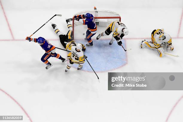 Anthony Beauvillier of the New York Islanders celebrates his second period goal as Matt Murray of the Pittsburgh Penguins reacts in Game Two of the...