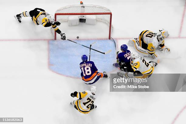 Anthony Beauvillier of the New York Islanders scores a second period goal past a diving Erik Gudbranson of the Pittsburgh Penguins in Game Two of the...