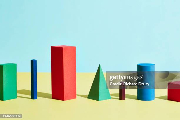 conceptual image of geometric blocks - cylinder pyramid stock pictures, royalty-free photos & images