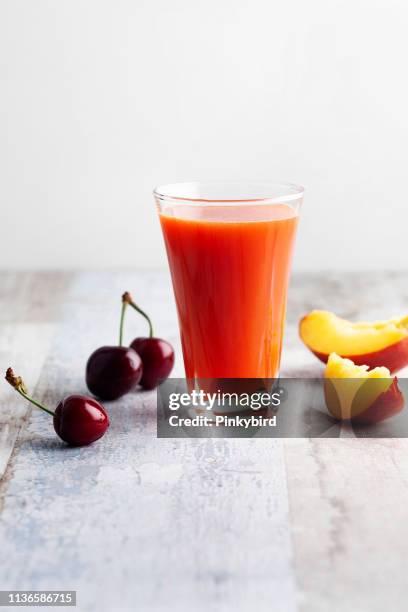 cherry fruit and peach smoothie in glass,peach juice - vegetable juice stock pictures, royalty-free photos & images