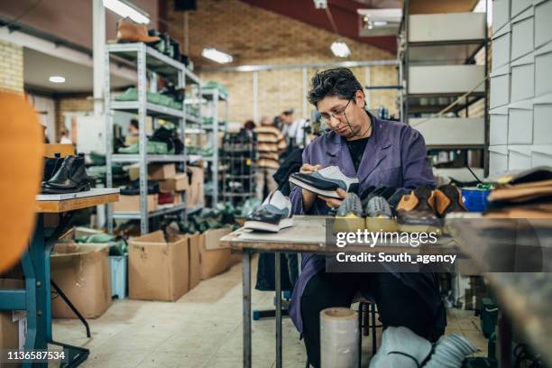 mature lady working at shoe factory - shoe factory stock pictures, royalty-free photos & images