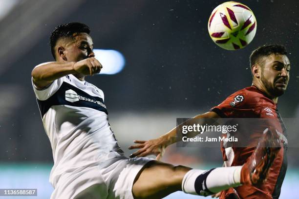 Brian Mansilla of Gimnasia y Esgrima fights for the ball with Leonel Ferroni of Newell's All Boys during a during a match between Gimnasia and...