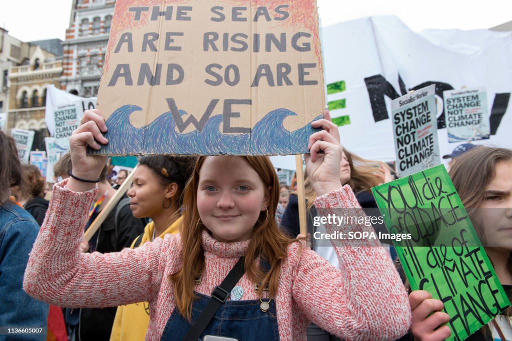 A student is seen holding a placard reading The seas are...