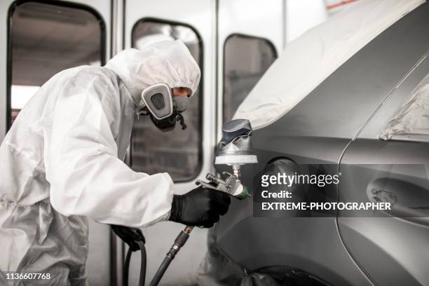 Car Colorist Painting The Side Of A Car In A Painting Booth Using A Paint  Spray Gun High-Res Stock Photo - Getty Images