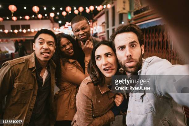 friends take selfie in chinatown downtown los angeles at night - organised group photo stock pictures, royalty-free photos & images