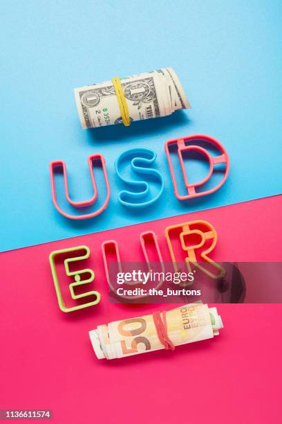 still life of usd and eur letters and roll of american dollar and euro banknotes - fajo de billetes de euro fotografías e imágenes de stock