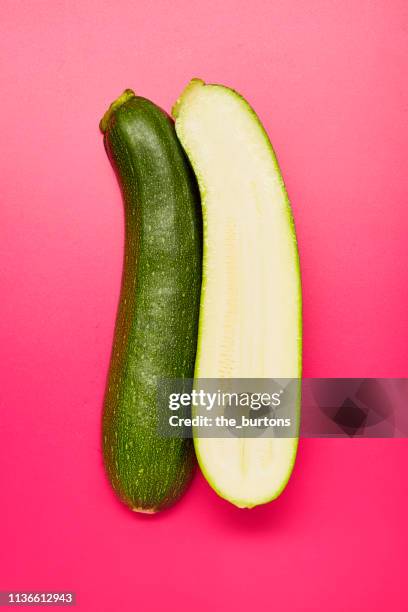 still life of sliced courgette on pink background - courgette stock pictures, royalty-free photos & images