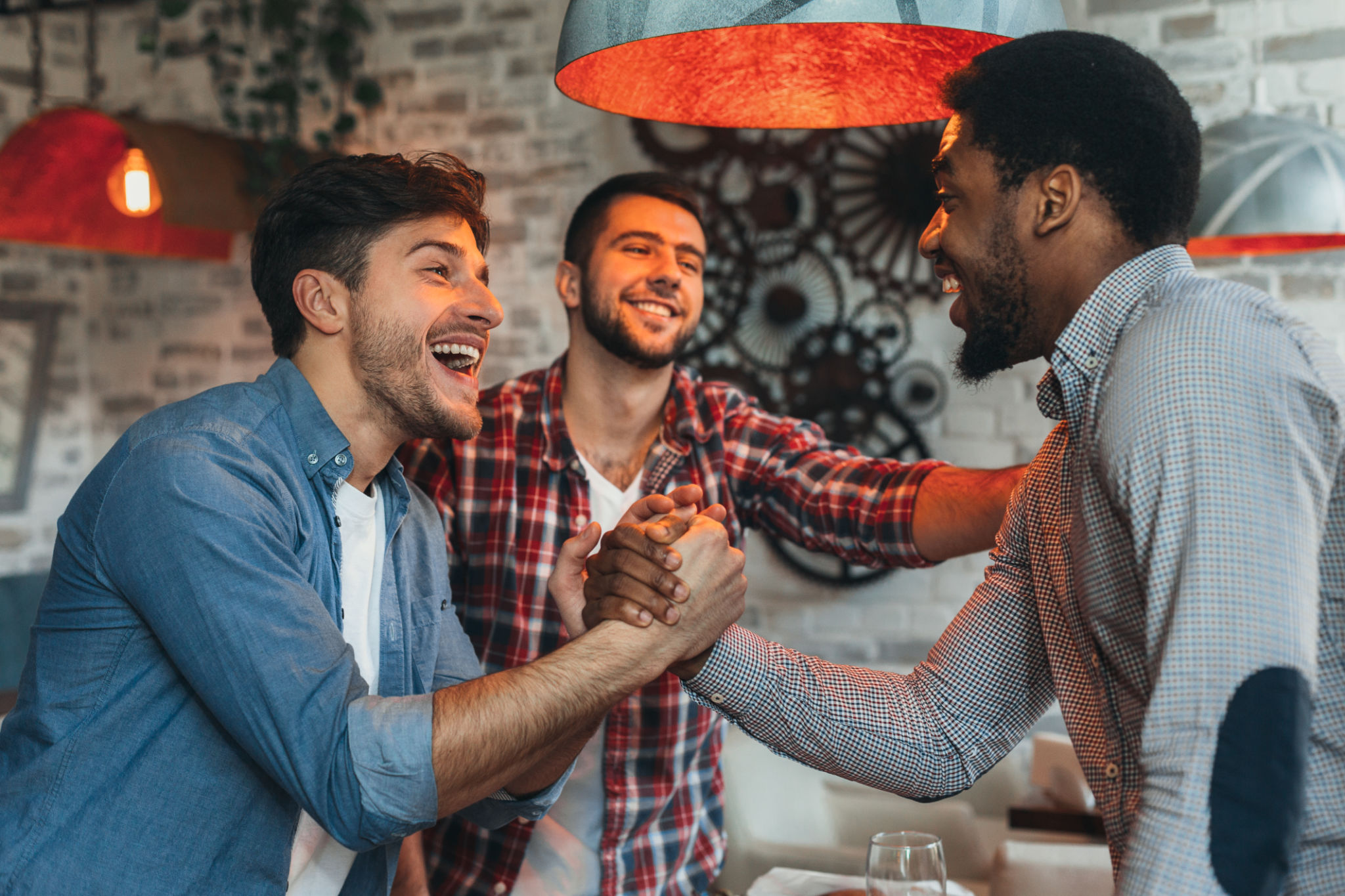 Old friends meeting. Three friends meet in pub Old friends meeting. Three friends meet in pub