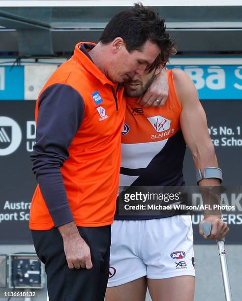 Wayne Campbell consoles Callan Ward of the Giants during the 2019 AFL round 04 match between the Geelong Cats and the GWS Giants at GMHBA Stadium on...