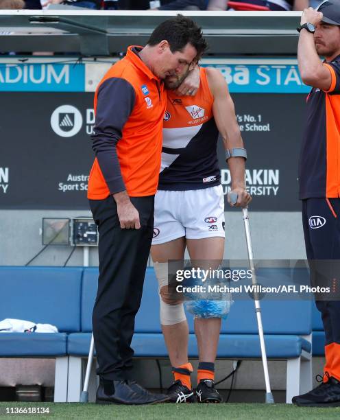 Wayne Campbell consoles Callan Ward of the Giants during the 2019 AFL round 04 match between the Geelong Cats and the GWS Giants at GMHBA Stadium on...