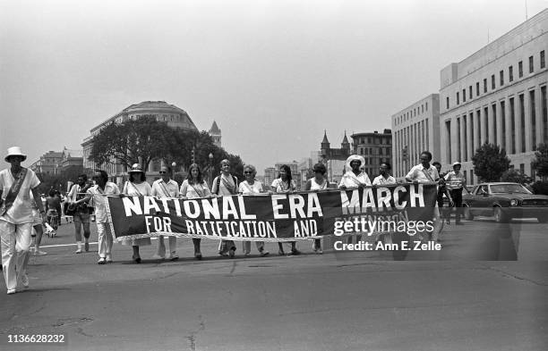 View of demonstrators as they carry a banner on Pennsylvania Avenue during the Equal Rights Amendment March, Washington DC, July 9, 1978. Their...