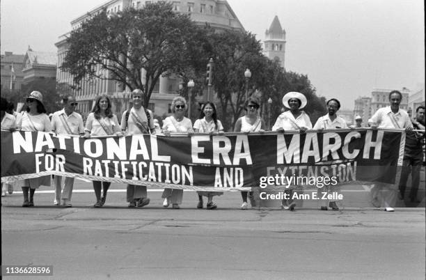 View of demonstrators as they carry a banner on Pennsylvania Avenue during the Equal Rights Amendment March, Washington DC, July 9, 1978. Their...