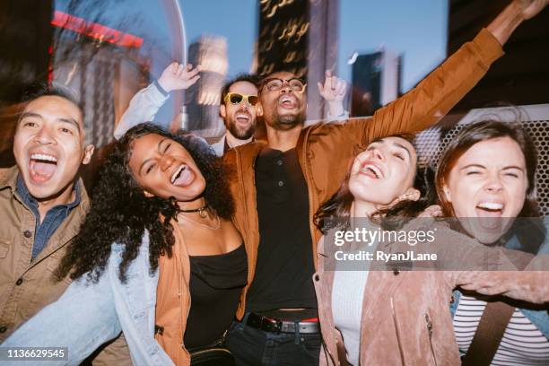 friends have fun on downtown los angeles rooftop - rooftop party night stock pictures, royalty-free photos & images