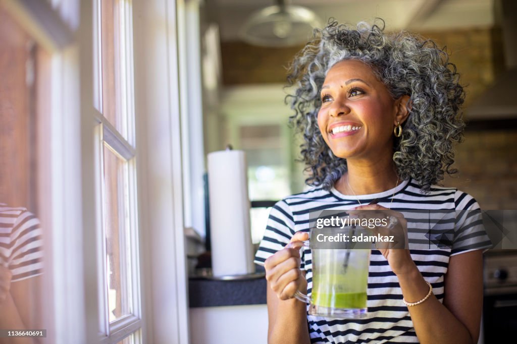 Mature Black Woman Drinking a Green Smoothie
