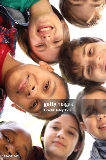 multi-ethnic group of pre-teenagers hanging out in park with friends. - 12 13 girl closeup stock pictures, royalty-free photos & images