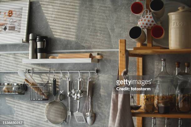 kitchen utensils hanging on the wall - kitchen shelves stock pictures, royalty-free photos & images